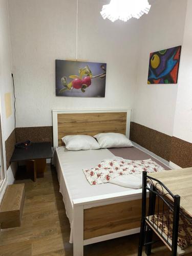 a bedroom with a bed and a painting on the wall at 9 Mai Central Studio in Sibiu