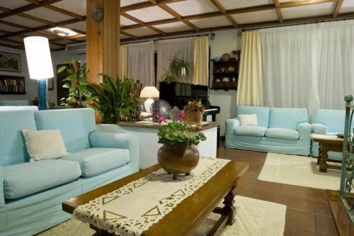 a living room with blue couches and a table at Costa Dorada in Cala Gonone