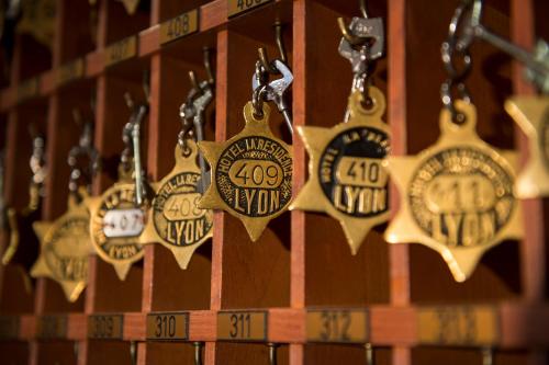 a bunch of clocks hanging on a wall at La Résidence in Lyon