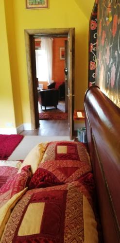 a bedroom with a bed and a living room at Penmachno Hall - self catering suite in Betws-y-coed