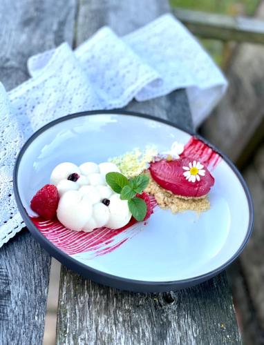 a plate of food on a wooden table at István Parkhotel és Gasztrofarm in Sormás