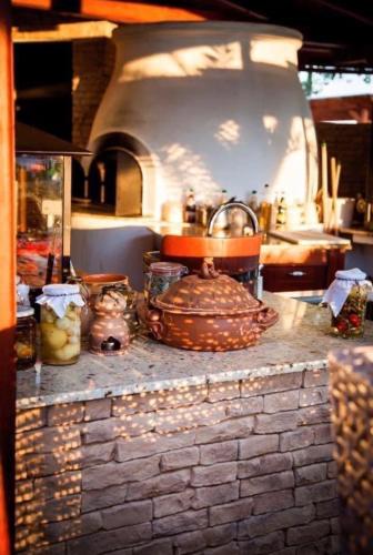 a kitchen with a stone counter with a pot on it at István Parkhotel és Gasztrofarm in Sormás