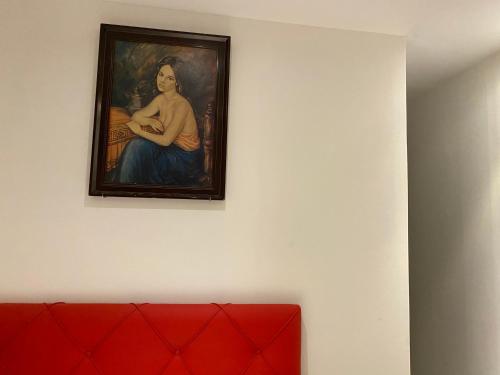 a painting of a woman hanging on a wall at Hostal Granvia 628 in Barcelona