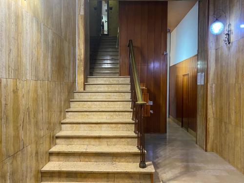 a staircase in a building with wooden walls and wooden floors at Hostal Granvia 628 in Barcelona