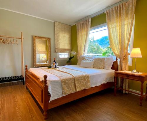 a bedroom with a large bed and a window at Paneon Apartments in Iraklitsa