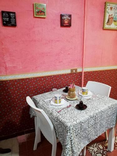 a table with a cake on top of it at B&B Orchidea in Palermo