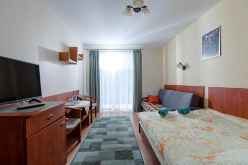 a hotel room with a bed and a television at Malinka in Rewal