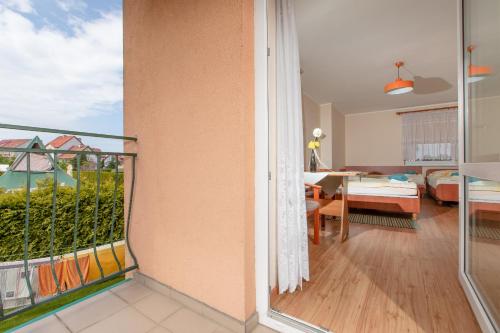 a balcony with a view of a living room at Malinka in Rewal