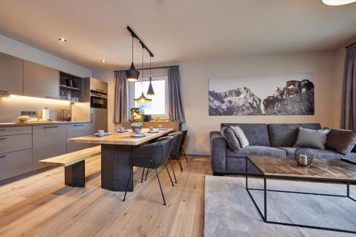 a kitchen and living room with a couch and a table at moun10 urlaubswohnen in Garmisch-Partenkirchen