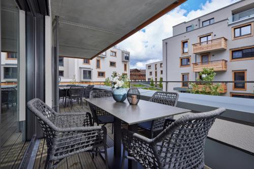 a patio with a table and chairs on a balcony at moun10 urlaubswohnen in Garmisch-Partenkirchen
