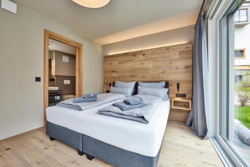 a bedroom with a large bed and a large window at moun10 urlaubswohnen in Garmisch-Partenkirchen