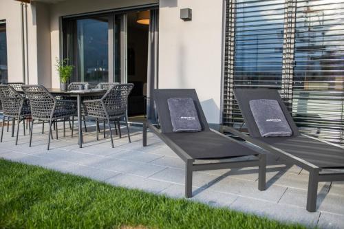 a group of chairs and a table on a patio at moun10 urlaubswohnen in Garmisch-Partenkirchen
