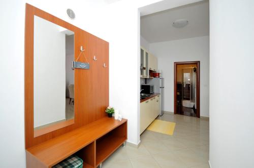 a living room with a large mirror on the wall at Apartments Roza in Trogir
