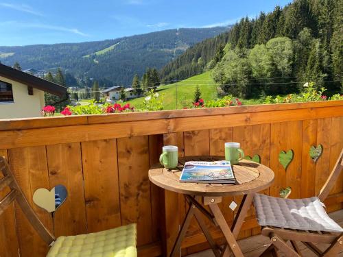 a balcony with a table with a laptop on it at Haus Filzmoos in Filzmoos
