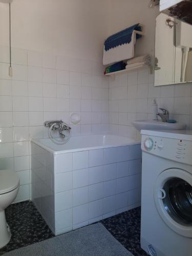 a bathroom with a washing machine and a washer at STARI DVORI POLJICA in Poljica