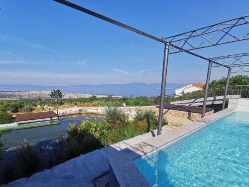 a swimming pool in a villa with a view at Villa Suzi Donkey farm with seaview in Šmrika