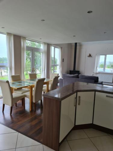 a kitchen and living room with a table and chairs at The Grove in Belturbet