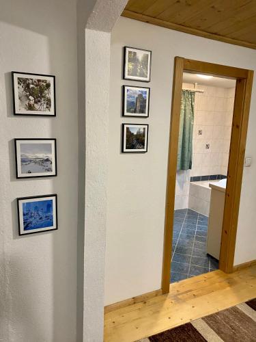 a hallway with pictures on the wall in a house at Apart Larcher in Arzl im Pitztal