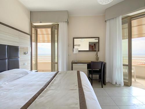 Postel nebo postele na pokoji v ubytování Hotel Capri & Residence