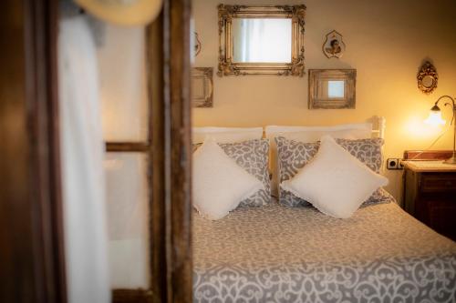 a bedroom with a bed with pillows and a window at Hostalet dels Indians in Begur