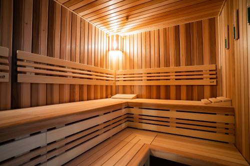 a wooden sauna with a light in the middle at ASTORIA Hotel & Medical Spa in Karlovy Vary