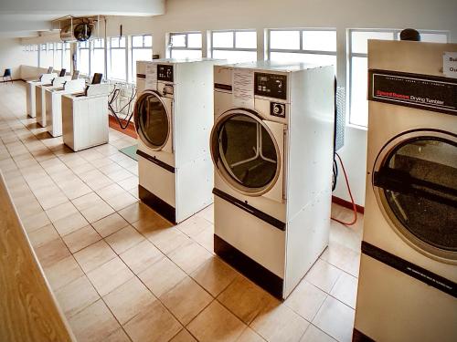a row of washers and dryers in a room at Ashley on Beach in Strand