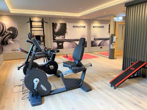 a gym with two treadmills and two exercise bikes at moun10 urlaubswohnen in Garmisch-Partenkirchen