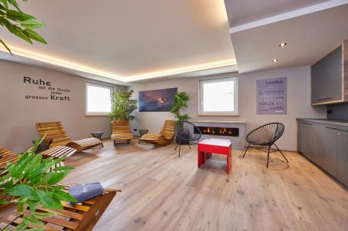 a large room with chairs and a table and a fire place at moun10 urlaubswohnen in Garmisch-Partenkirchen