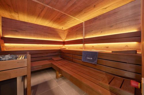a wooden sauna with a bench in a room at moun10 urlaubswohnen in Garmisch-Partenkirchen