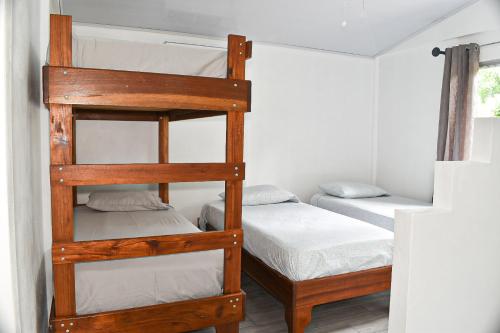 a bunk bed room with two bunk beds at Tropical Paradise Bungalows in Pital