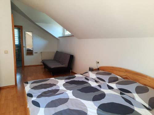 a bedroom with a bed and a chair at Ferienwohnung Berger in Gmünd in Kärnten