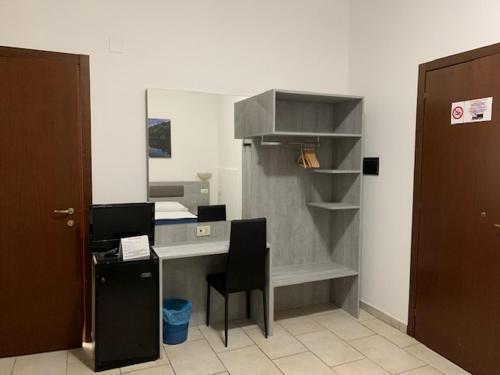 an office with a desk and a chair in a room at Hotel Alessander in Milan