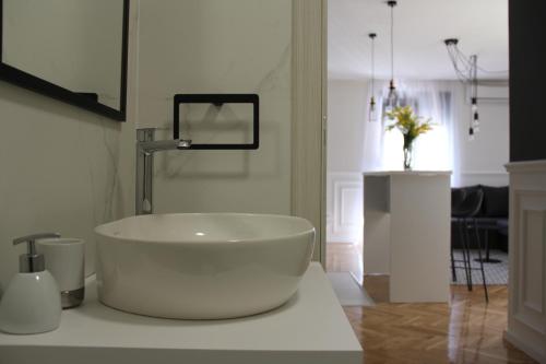 a bathroom with a large white tub on a counter at Apartments Marković in Kotor