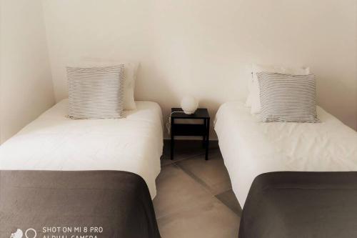 two beds sitting next to each other in a room at Old Town House in Loulé