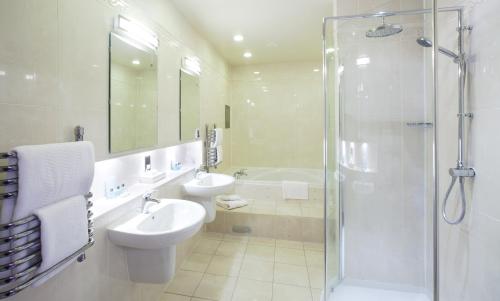 a bathroom with a toilet sink and a shower at Appleby Manor Hotel & Garden Spa in Appleby