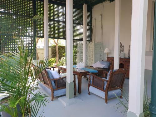 a patio with a table and chairs on a porch at Anglesey House Iconic Forbes CBD Heritage Home in Forbes