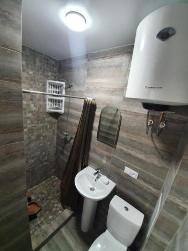 a bathroom with a toilet and a sink at Silver 2 Затока in Zatoka