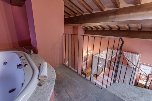 a bathroom with a sink and a iron gate at PALAZZO DEL CAPITANO Wellness & Relais - Luxury Borgo Capitano Collection in San Quirico dʼOrcia