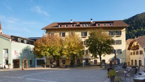 a large building on a street in a town at Parkhotel Post in Chiusa