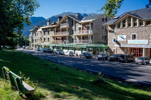 a street with cars parked on the side of the road at Hotel et Résidence Le Clos Cerdan in Mont-Louis