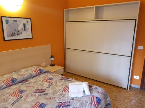 a bedroom with a bed and a large closet at Hotel La Torre in Cogoleto