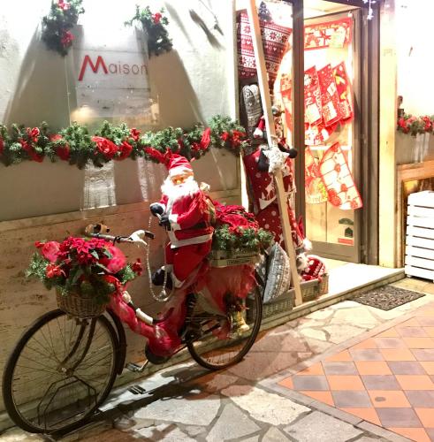 a santa claus bike parked in front of a store at Piccola Navetta in Diano San Pietro