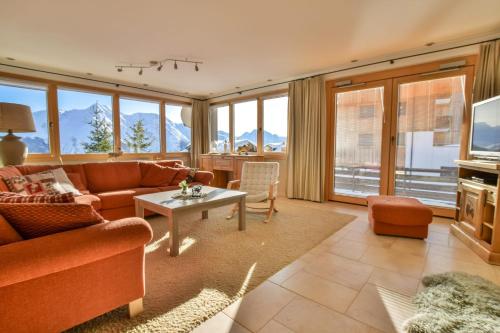 a living room with a couch and a table at Topas 7 in Bettmeralp