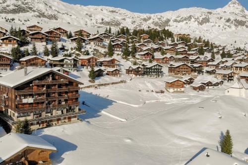 a resort in the snow with snow covered buildings at Topas 7 in Bettmeralp