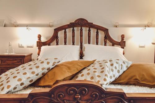 a bed with brown and white pillows on it at Masseria del Vino in Loreto Aprutino