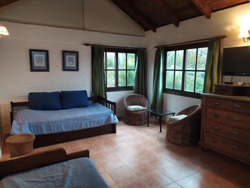 a bedroom with a bed and a tv in a room at Casa Roja in Playa Verde