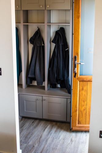 a closet filled with hangers with black jackets at Barker Stakes Farm in Pickering