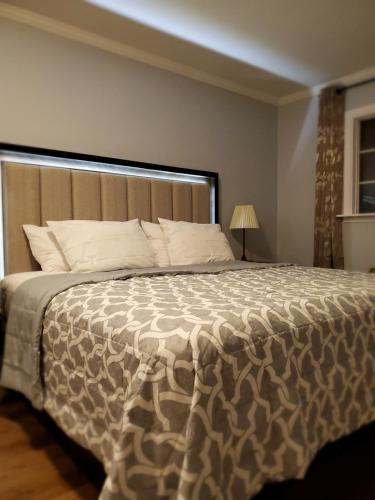 a bedroom with a large bed with a large headboard at Hotel Europa in Smeltzer