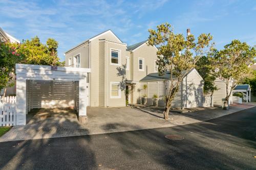 a large house with a garage in the driveway at Avocet Nest on Thesen Island in Knysna