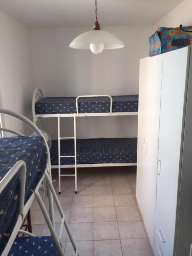 a room with two bunk beds and a cabinet at Buggerru fuori dal tempo in Buggerru